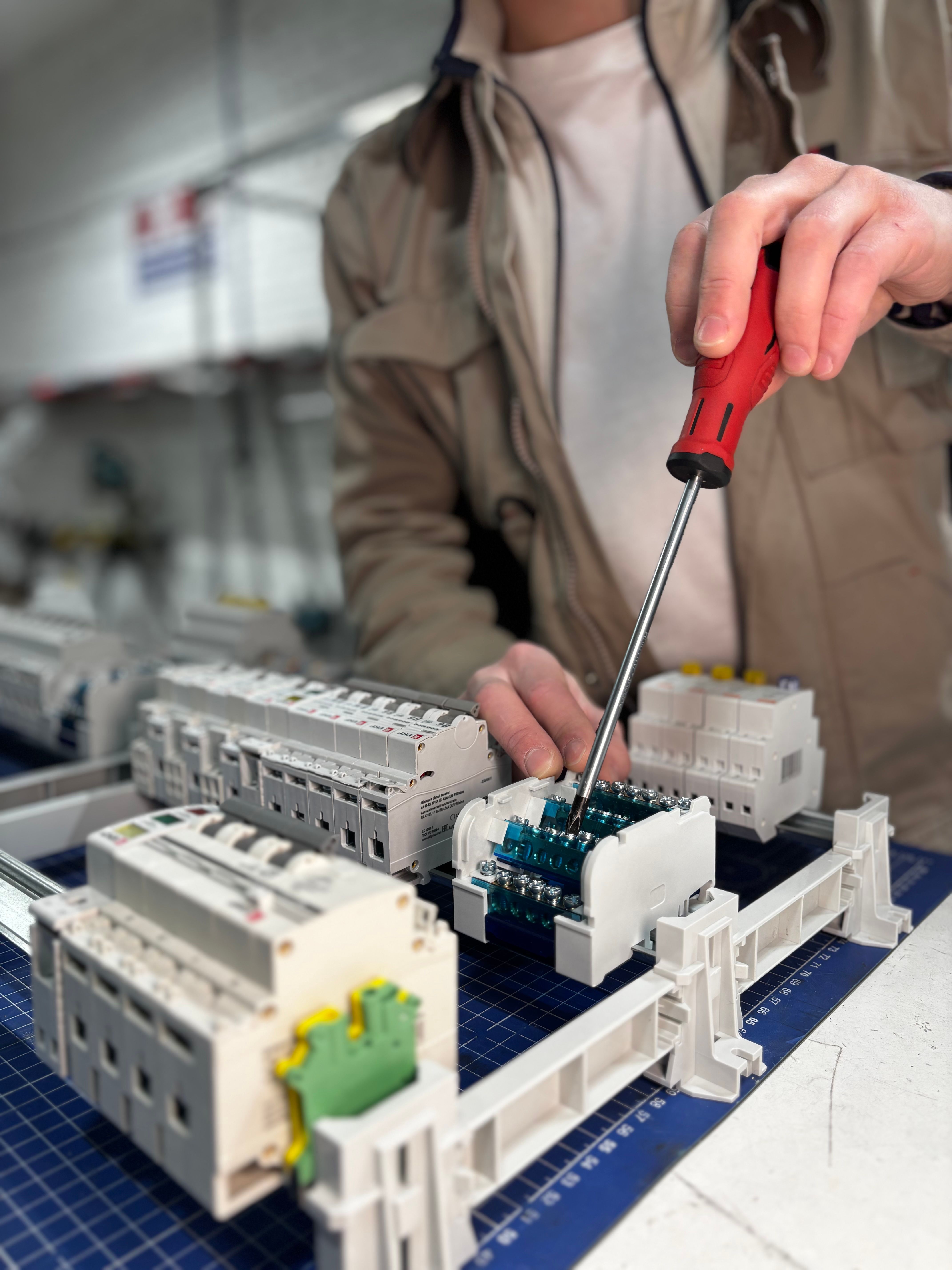 Electrician working carefully on an electrical board